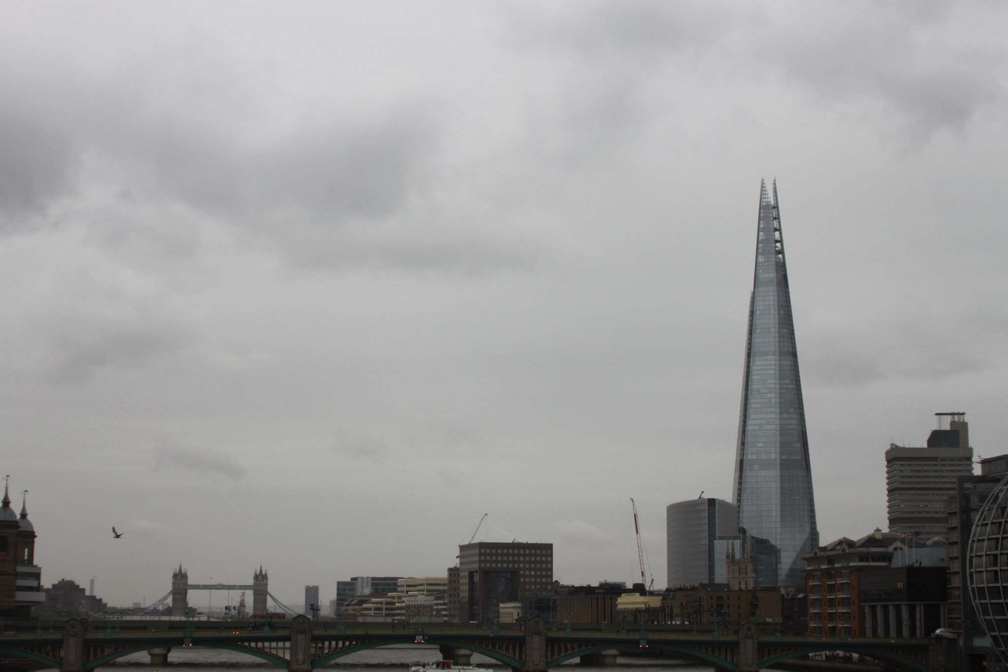 'The Shard' in landscape with London Bridge in the forground and Tower Bridge in the distance.